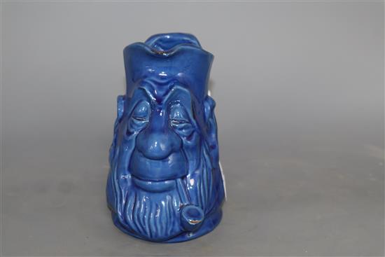 A C.H. Brannam blue glazed double mask jug, height 15cm